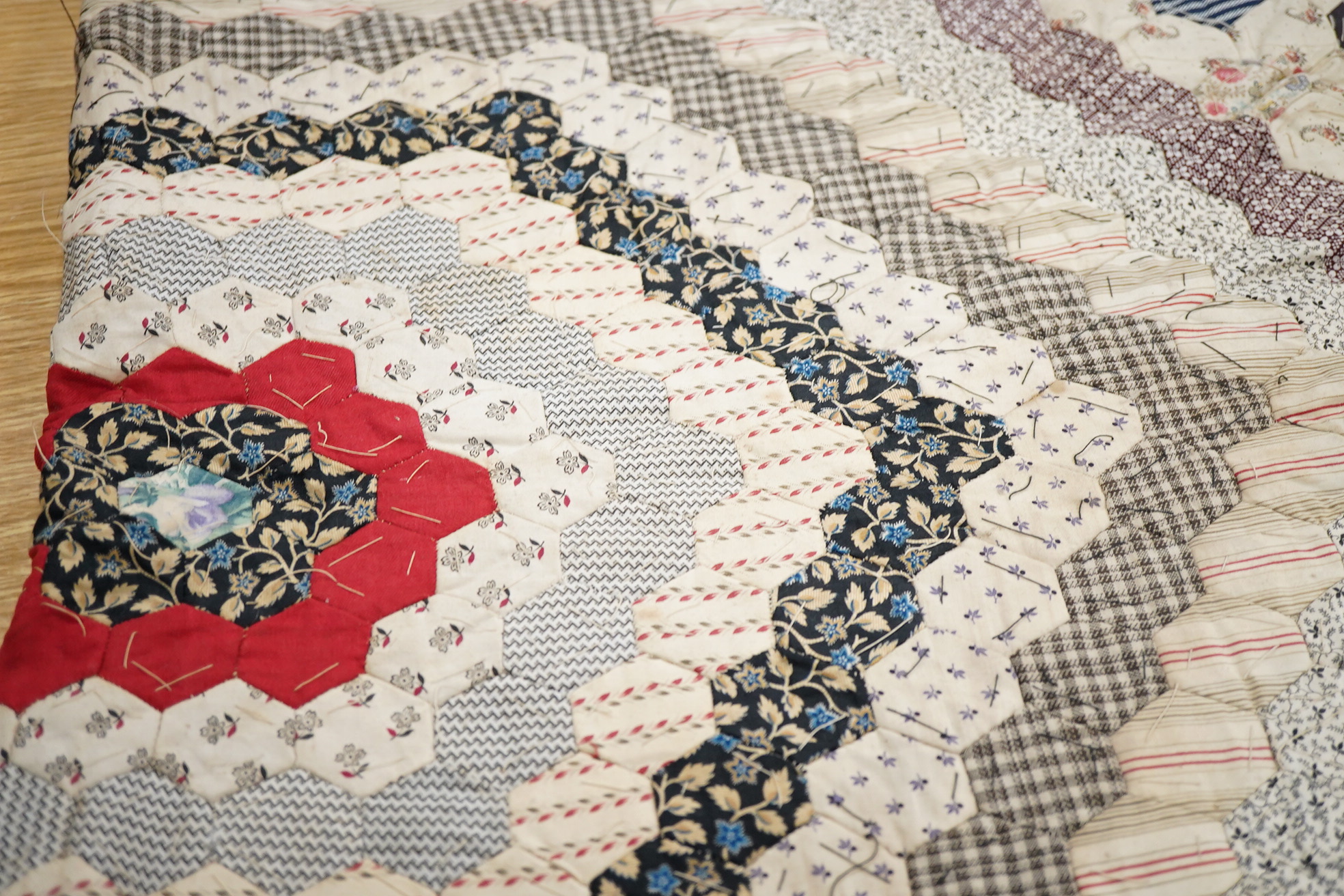A 19th century alphabet cross stitch sampler, worked with a large house motif - 41cm x 29cm, together with a 19th century unfinished cotton patch worked central panel. Condition - the sampler has some stains but the thre